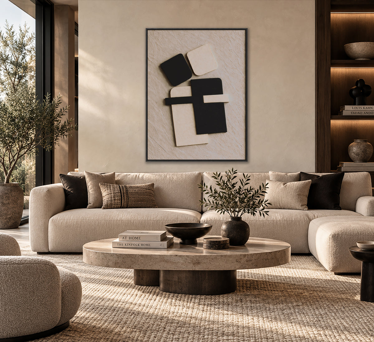 a modern living room with a large beige sofa, a round coffee table, and a framed abstract artwork on the wall.