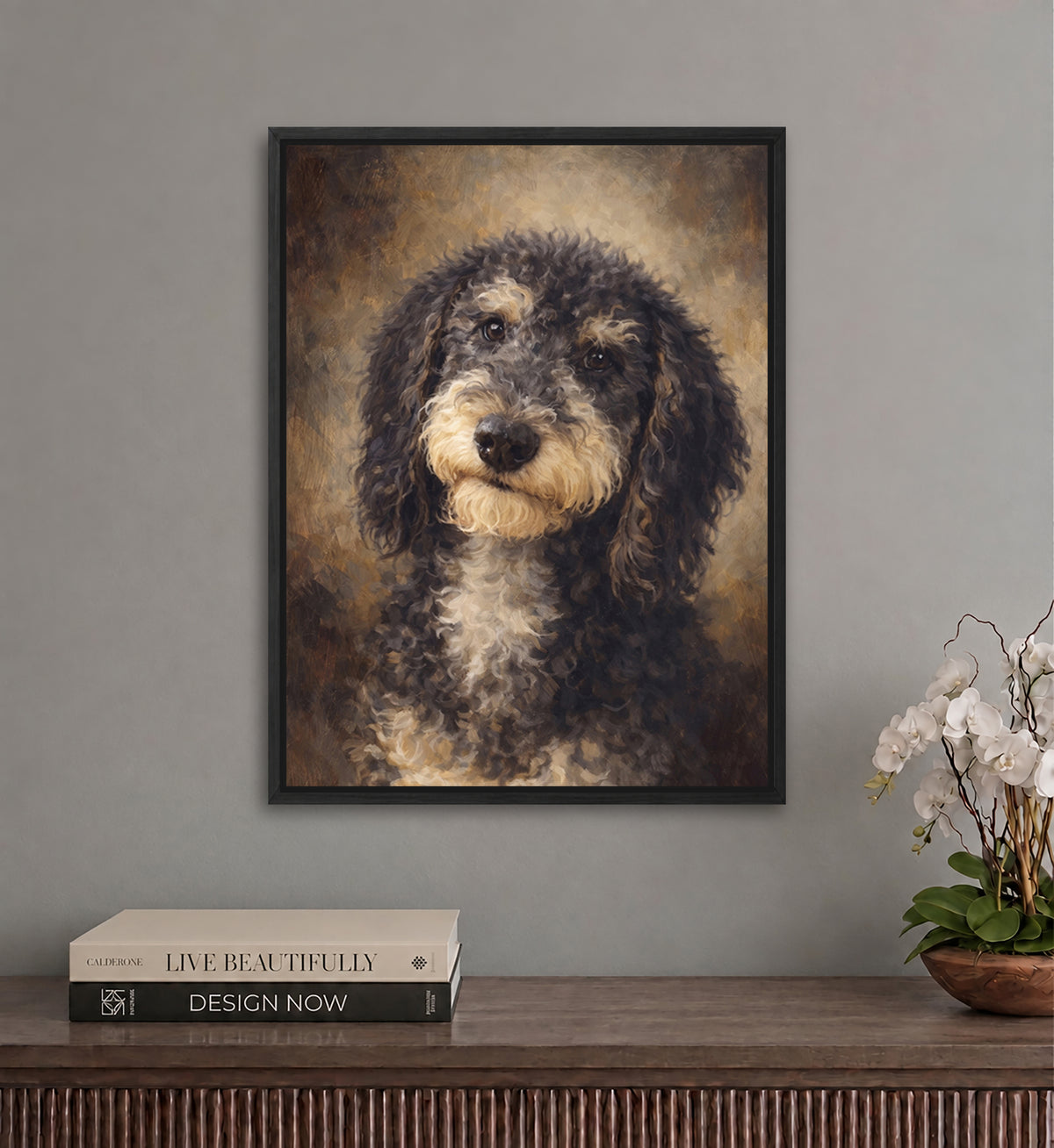 a framed painting of a dog with a pensive expression, hanging on a wall above a wooden table with a stack of books and a potted plant.
