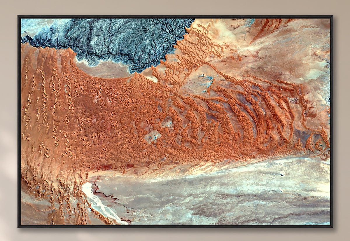 Aerial view of the Naukluft region in Namibia showing burnt orange, blue-grey and pale stone desert formations