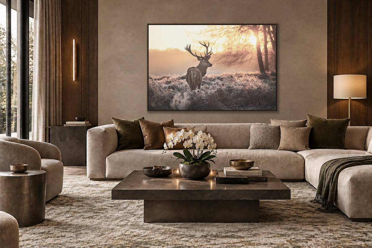 a serene living room with a large painting of a deer in a snowy forest scene hanging on the wall. The room is furnished with a sofa, a coffee table, and a lamp, creating a cozy and inviting atmosphere.