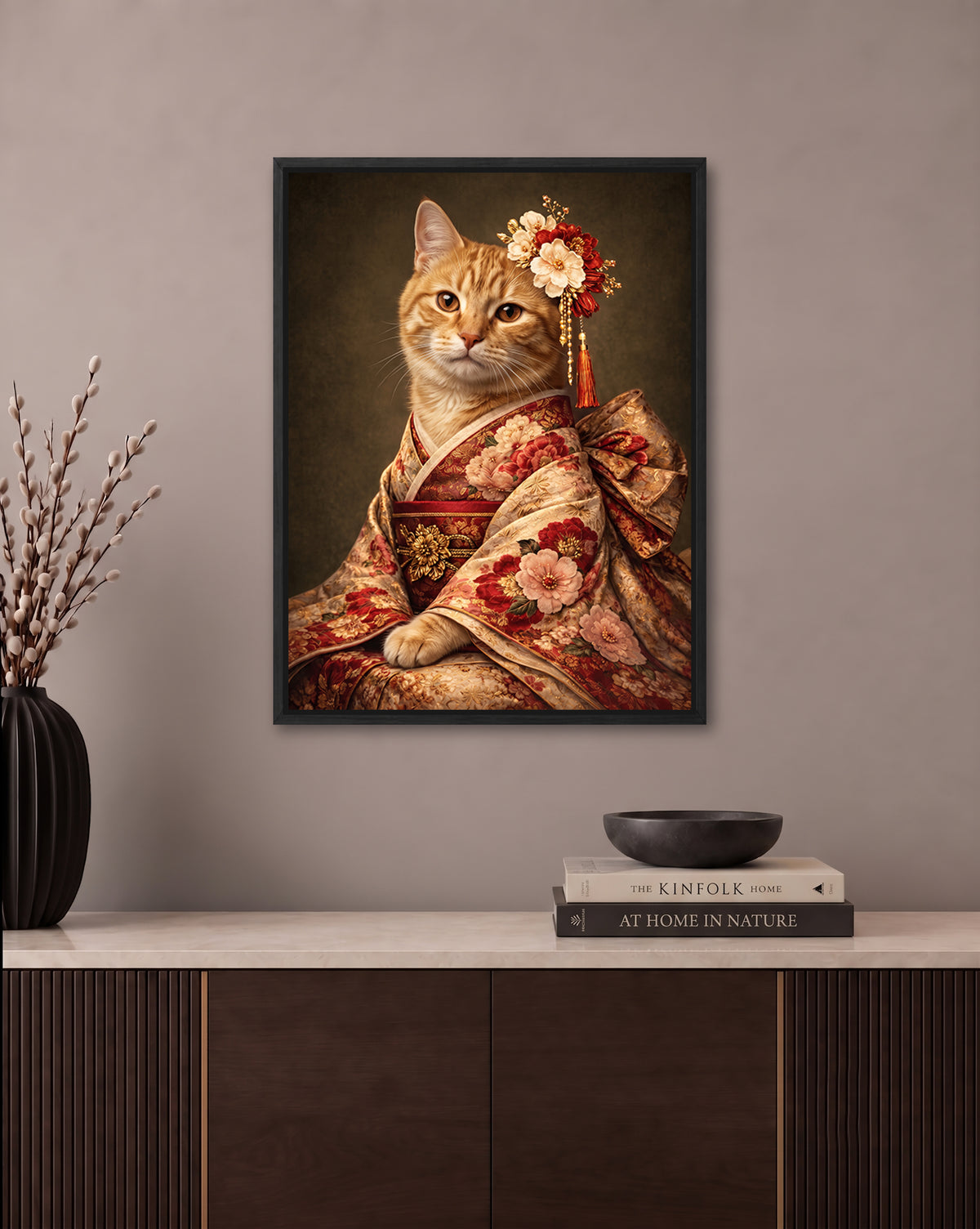 a framed portrait of a cat wearing a kimono, with a floral headpiece, displayed on a wall above a wooden cabinet.
