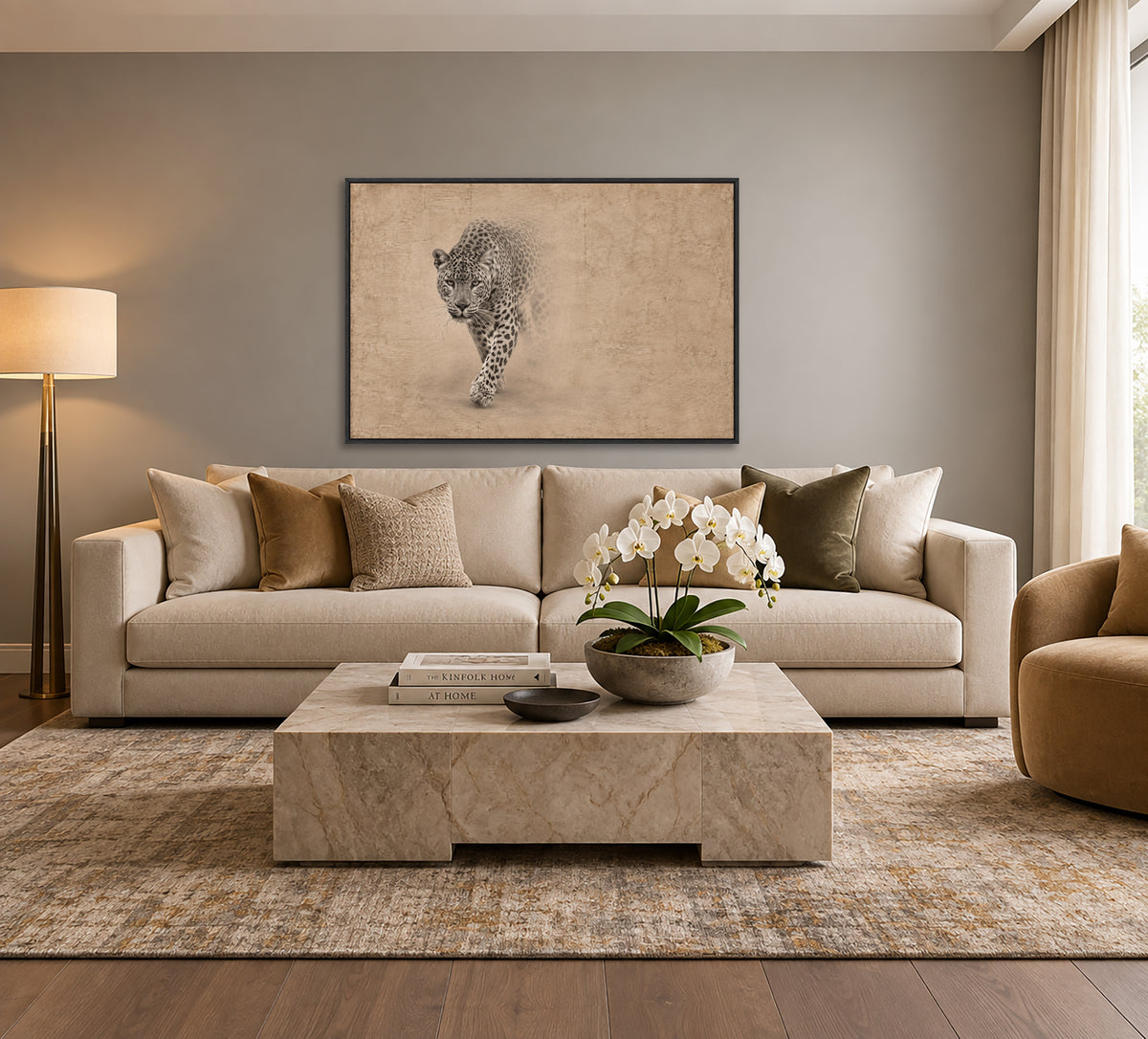 a modern living room with a large beige sofa, a marble coffee table, and a framed artwork of a leopard on the wall.