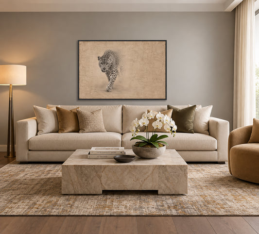 a modern living room with a large beige sofa, a marble coffee table, and a framed artwork of a leopard on the wall.