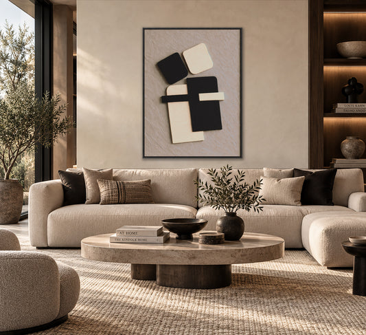a modern living room with a large beige sofa, a round coffee table, and a framed abstract artwork on the wall.