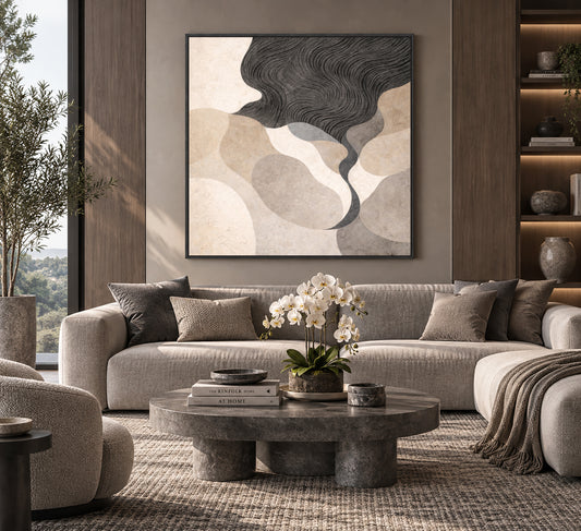 a modern living room with a large abstract painting on the wall, a gray sofa, a round coffee table with a vase of white flowers, and a bookshelf with various decorative items.