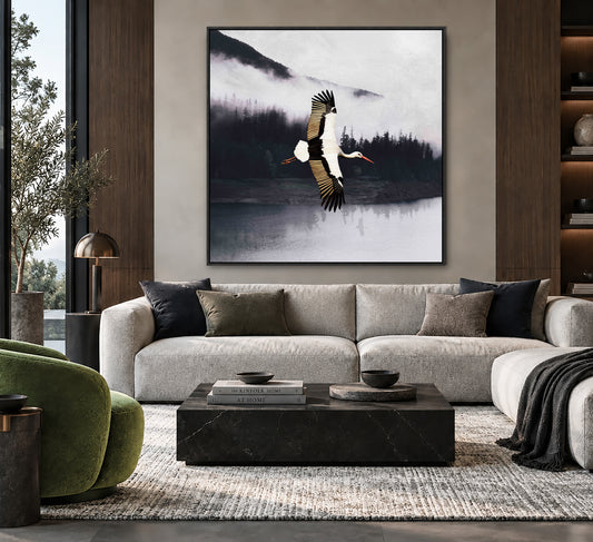 a large framed painting of a bird in flight above a sofa in a modern living room setting.