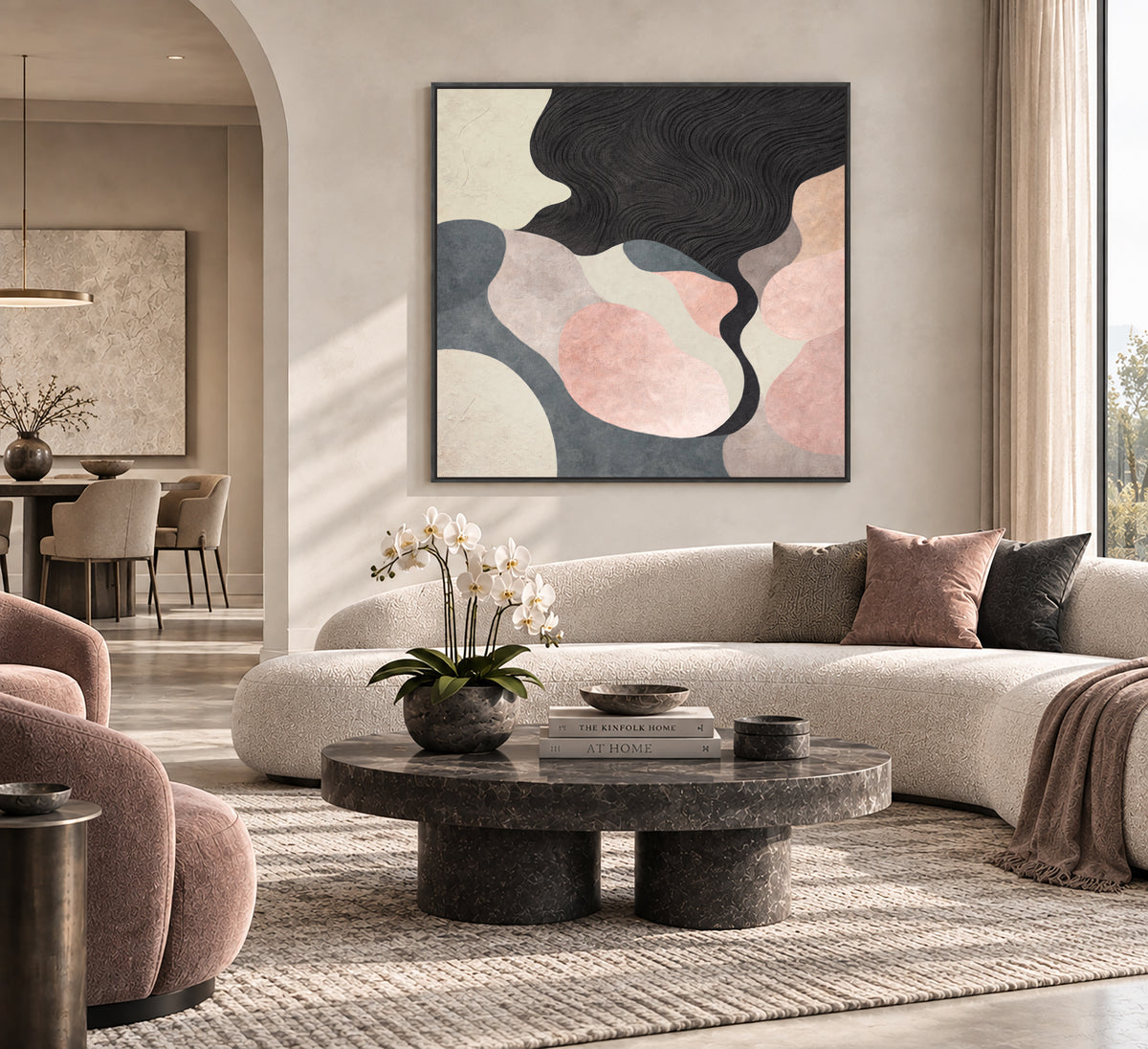 a modern and stylish living room with a large abstract painting on the wall, a round coffee table with a vase of white flowers, a plush white sofa, and a large window overlooking the outdoors.